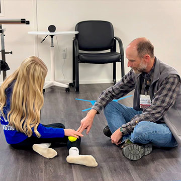 A medical professional assists a patient with her physical therapy. Links to What to Give A medical professional assists a patient with her physical therapy. Links to What to Give