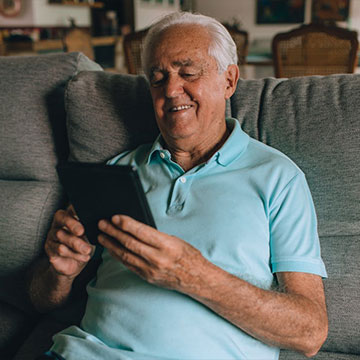 An elderly man reading something on a tablet device. Links to Beneficiary Designations An elderly man reading something on a tablet device. Links to Beneficiary Designations